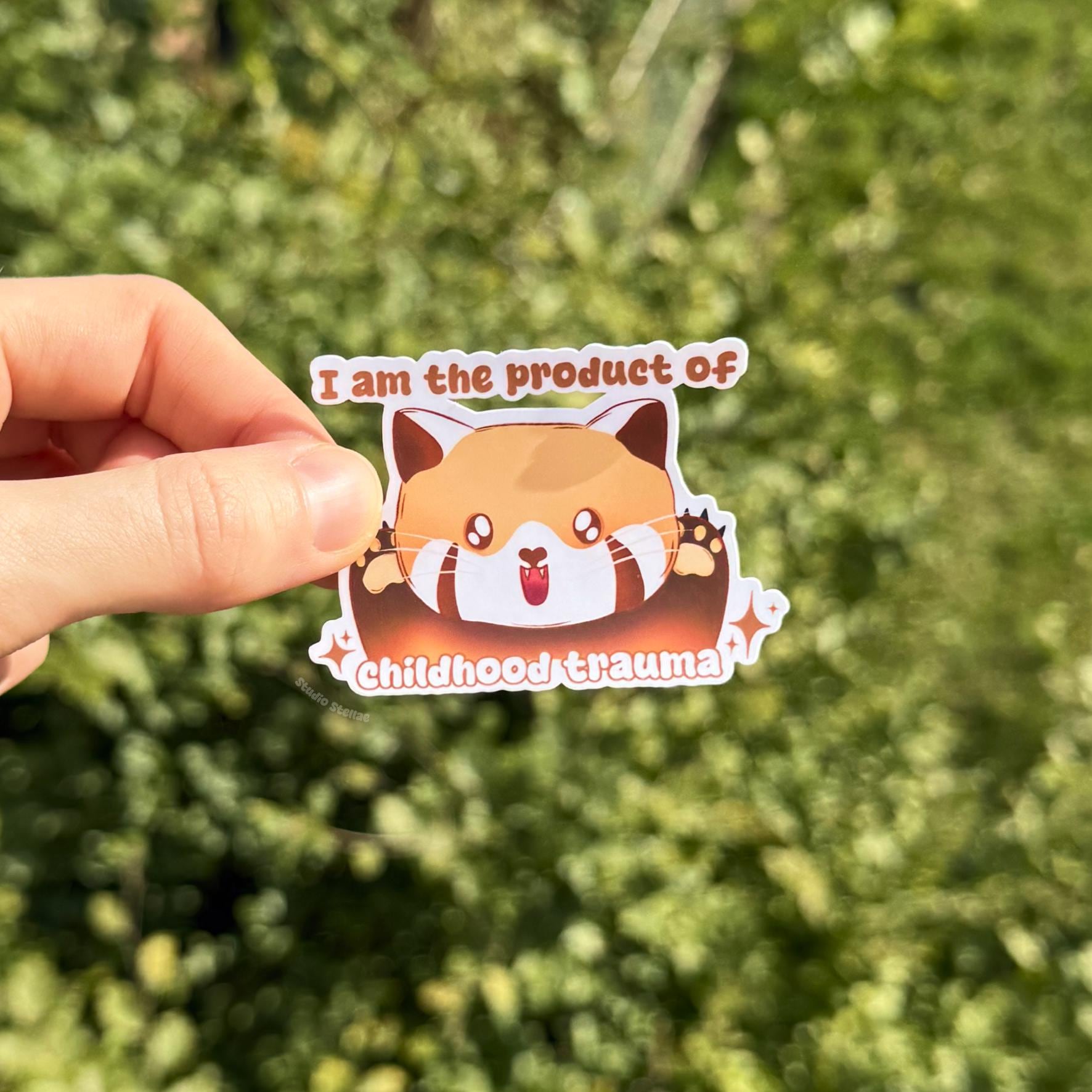 Close-up of the red panda sticker held in a hand outdoors against soft greenery to show true size and color detail. The kawaii animal design and humorous quote stand out clearly in natural light. This handmade matte vinyl decal is perfectly sized for laptops, planners, water bottles and everyday decoration.