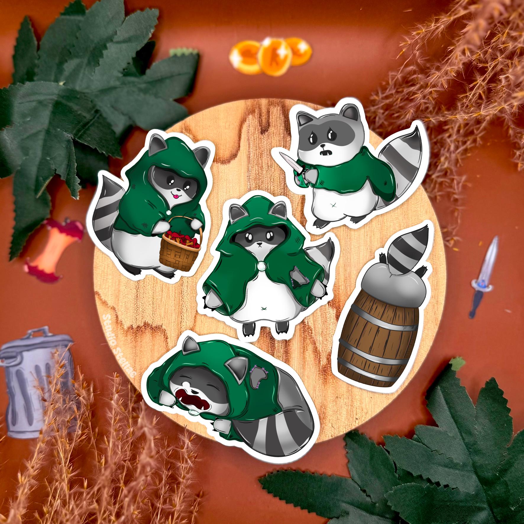 Rogue raccoon DnD sticker set arranged on a fantasy themed tabletop with dice, greenery, and cozy props, featuring multiple chibi trash panda characters dressed as sneaky rogues and adventurers. This tabletop RPG sticker pack highlights the playful fantasy vibe and handmade details, making it a perfect gift for dungeon masters, DnD players, and tabletop RPG fans who want to decorate laptops, dice boxes, journals, or water bottles with cute fantasy animal art.